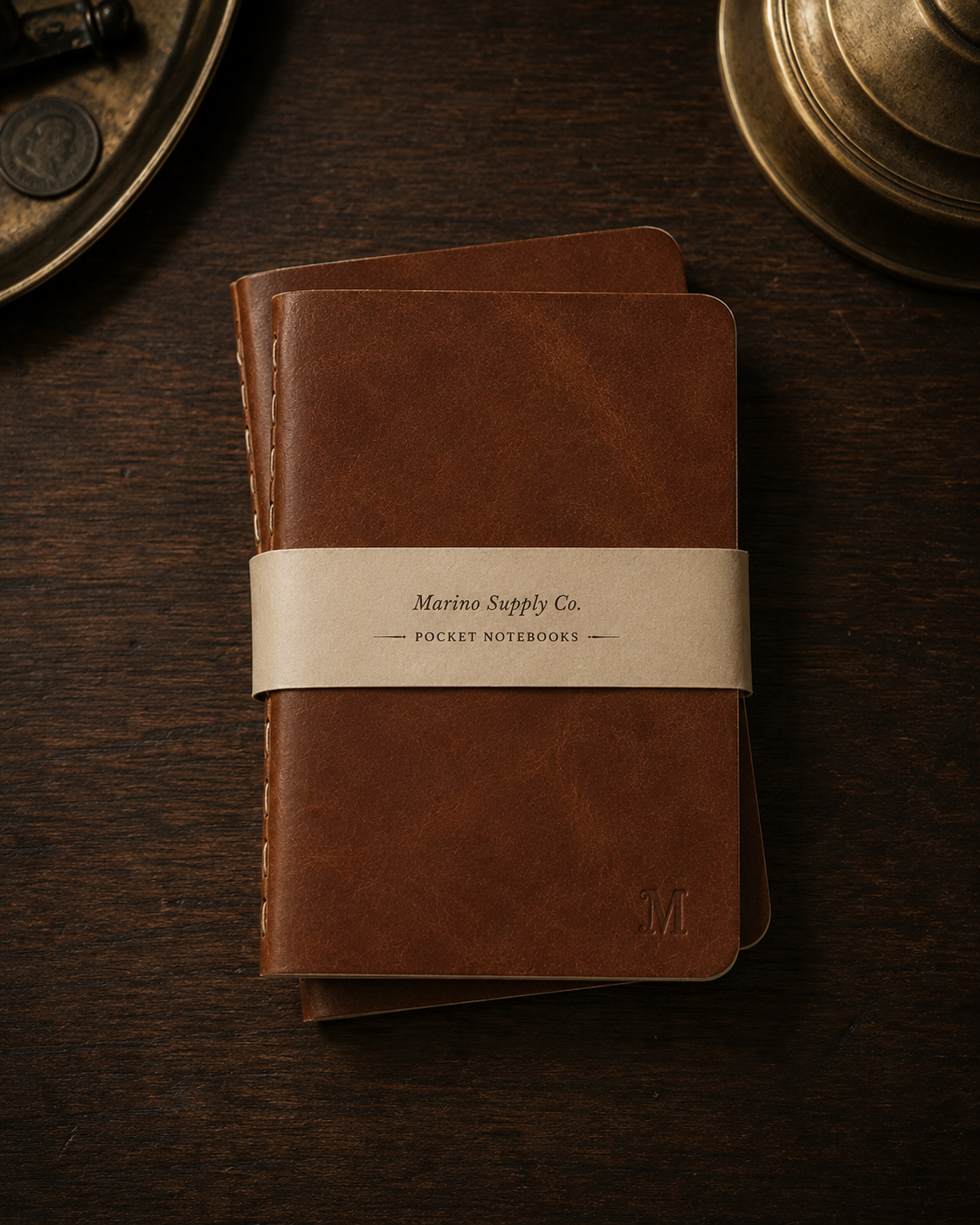 The Correspondence Notebooks, a pair of A6 leather-bound books on a dark wood surface.